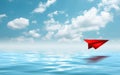 Red paperplane in the beautiful seascape with cloud on a sunny day Royalty Free Stock Photo