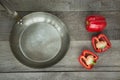 Red paprika and pan on vintage wooden board for your recipe. Top view with copy space. Royalty Free Stock Photo