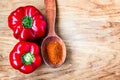 Red Paprika powder in wooden spoon and fresh sweet red pepper food spice ingredient close up Royalty Free Stock Photo