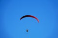 Red paraglider in a blue sky Royalty Free Stock Photo