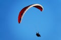Red paraglider in a blue sky Royalty Free Stock Photo