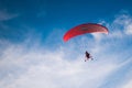 Red paraglider on a cloudy background Royalty Free Stock Photo