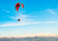 Red paraglider flying in the blue sky near Oludeniz in Turkey