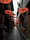 Red Parasols Hanging Over Alley in China