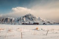 The red Parish church with mountain in snowy at Flakstad Royalty Free Stock Photo