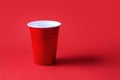 Red party cup on red background. Beer pong tournament. Royalty Free Stock Photo