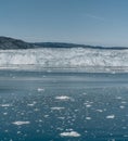 Red Passenger cruise ship sailing through the icy waters of Qasigiannguit, Greenland with Eqip Sermia Eqi Glacier in Royalty Free Stock Photo