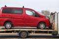 Red passenger minibus is transported by tow truck. Car evacuation, transfer, delivery to a car service Royalty Free Stock Photo