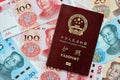Red passport of People Republic of China and chinese yuan money bills. PRC chinese passport Royalty Free Stock Photo