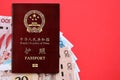 Red passport of People Republic of China and chinese yuan money bills. PRC chinese passport Royalty Free Stock Photo