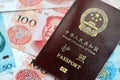 Red passport of People Republic of China and chinese yuan money bills. PRC chinese passport Royalty Free Stock Photo