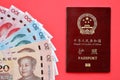 Red passport of People Republic of China and chinese yuan money bills. PRC chinese passport Royalty Free Stock Photo