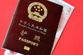 Red passport of People Republic of China and chinese yuan money bills. PRC chinese passport Royalty Free Stock Photo