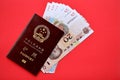 Red passport of People Republic of China and chinese yuan money bills. PRC chinese passport Royalty Free Stock Photo