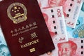 Red passport of People Republic of China and chinese yuan money bills. PRC chinese passport Royalty Free Stock Photo