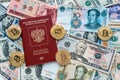 The red passport Russian. Against paper money, US dollars, Chinese yuan CNY, metal coins, bitcoin, crypto currency Royalty Free Stock Photo
