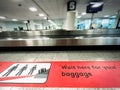 A red patch on the floor indicating where to wait for baggage claim at an airport