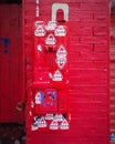 Grungy Old Pay Phone with Graffiti Stickers on Red Brick Urban Wall. Can be used as Background. Royalty Free Stock Photo