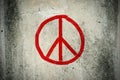 Red peace symbol graffiti on grunge ciment wall Royalty Free Stock Photo