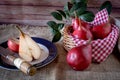 A red pear cut in half on a plate and other juicy red battler pears in a basket. Organic and natural products. Healthy food. High