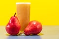 Red Pear Juice Pyrus communis Var. Red on yellow background