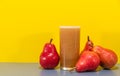 Red Pear Juice Pyrus communis Var. Red on yellow background