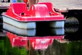 Red pedalo reflecting in water Royalty Free Stock Photo