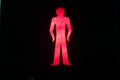 Red pedestrian don't walk sign on a black background Royalty Free Stock Photo