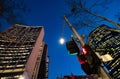 Red pedestrian traffic lights with high office buildings in the background at night Royalty Free Stock Photo