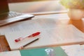 Red pen on blurred paperwork and books Royalty Free Stock Photo