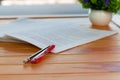 Red pen on blurred paperwork in office Royalty Free Stock Photo