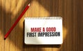 Red pen and notepad with text Make a good first impression in the white background Royalty Free Stock Photo