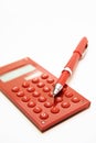 Red pen on the red calculator