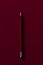 Red pencil on a red background with hard shadow. Perfect for the start of class. Red pencil for teacher qualifications. Royalty Free Stock Photo
