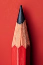 Red Pencil with black graphite tip on a red background