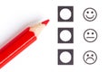 Red pencil choosing the right smiley Royalty Free Stock Photo