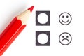 Red pencil choosing the right smiley Royalty Free Stock Photo