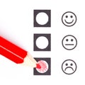 Red pencil choosing the right smiley Royalty Free Stock Photo