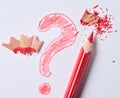 Red pencil and a drawn question mark with shavings on a white background Royalty Free Stock Photo