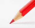 Red pencil draws or writing on white paper Royalty Free Stock Photo