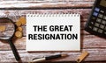 Red pencil, notebook on black copy space background with handwritten text THE GREAT RESIGNATION Royalty Free Stock Photo