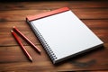 Red pencil and notepad on a wooden table for jotting goals and tasks