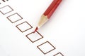 Red pencil and questionnaire on white paper. Royalty Free Stock Photo