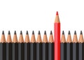 Red pencil standing out from crowd of plenty identical black fellows on white table Royalty Free Stock Photo