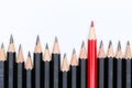 Red pencil standing out from crowd of plenty identical fellows Royalty Free Stock Photo