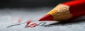 A red pencil tip closely scribes love in cursive script on white paper Royalty Free Stock Photo