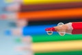 Red pencil with water drops close up macro shot Royalty Free Stock Photo