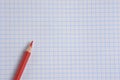 Red pencil on a white checkered background. Royalty Free Stock Photo