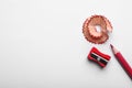 Red pencil, wooden shaving and sharpener on white background, top view Royalty Free Stock Photo