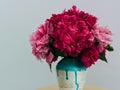 Red peonies in a handmade vase